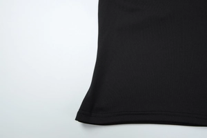Close-up of black halter top featuring high-quality double-needle hem and knit texture