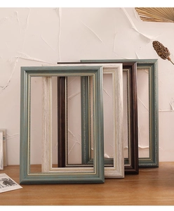 Detail of vintage European picture frames with elegant golden beaded edge carvings