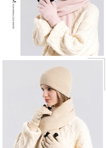 Close-up of knit winter set with beanie scarf and touchscreen gloves in soft pink and beige