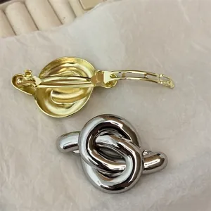 Elegant geometric knot metal hair clips in polished gold and silver finish set