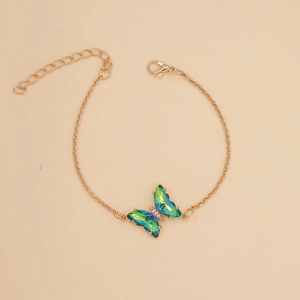 Detail of gold butterfly bracelet with green and blue gradient faceted crystal wings