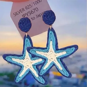 Handcrafted woven starfish earrings in blue and cream with silver needle for summer vacation