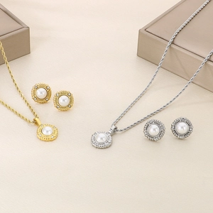 Detail of twisted chain necklace sets with pearl and crystal pendants in gold and silver