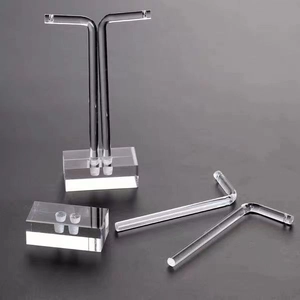 Macro detail of clear acrylic L-shaped earring stand and base with high transparency