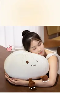Detail of soft bun plush pillow with cute cartoon face held by a female model