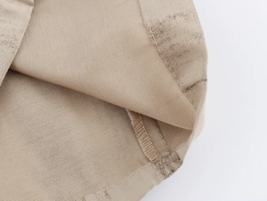 Vista macro dettagliata della trama del tessuto beige e delle cuciture sul set di gilet