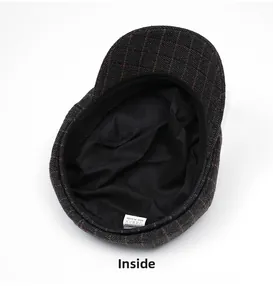 Detailed interior of vintage plaid newsboy hat featuring grey lining and wash label
