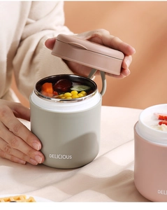 Close-up of portable stainless steel soup cup in green with vegetable soup inside