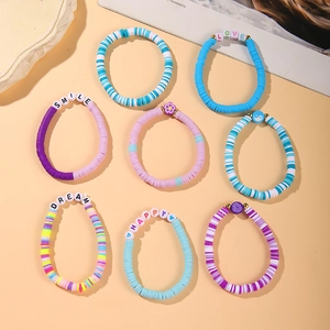 Detail of 8-piece polymer clay stretch bracelet set with flower and letter beads