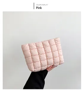 Detail of pink quilted cotton handbag with soft puffer texture and square grid design