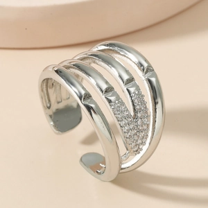 Macro detail of multi-layer silver open ring with sparkling pavé diamond accents
