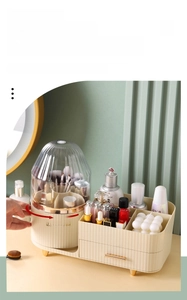 Detailed close-up of 360 rotating makeup organizer with gold handles and clear dustproof lid