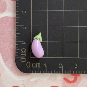 Miniature resin eggplant charm detail showing 1.5cm size on a professional measurement grid