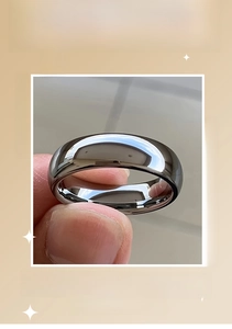 Macro close-up showing the high-polished mirror finish of a sleek minimalist silver ring