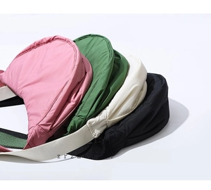 Detail of padded nylon crescent bags in pink, green, white, and black colors