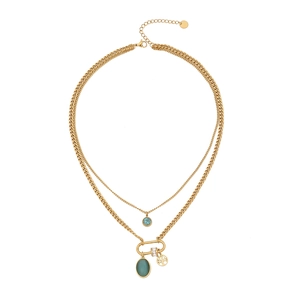 Double-layered gold necklace with turquoise bead and tree pendant on white background