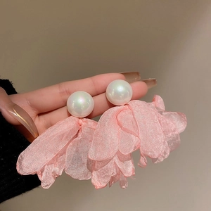 Detailed view of pink floral chiffon petals with a large white pearl on stud earrings