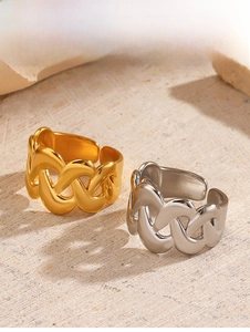 Detail shot of chunky intertwined chain link rings in gold and silver finish with open band