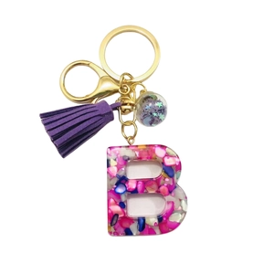 Letter B resin keychain with colorful iridescent flakes and purple tassel in gold finish
