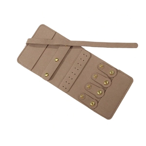 Macro-opname van de kaki suède sieraden organizer met ringbandjes en oorbelhouders