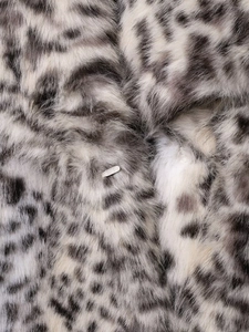 Close-up of high-density leopard print faux fur texture with a silver metal hardware detail
