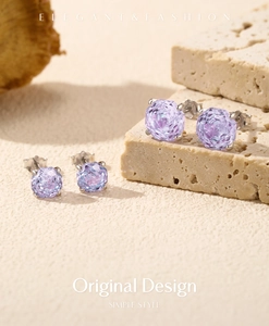 Macro detail of S925 silver amethyst stud earrings with four-prong settings on stone