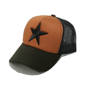 Close-up of distressed brim and 3D star embroidery on orange mesh trucker cap