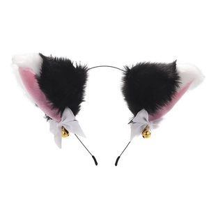 Detail of plush black and white cat ears with pink inner fur, white bows and gold bells