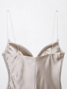 Detailed view of the champagne satin camisole featuring a V-neckline and smooth texture