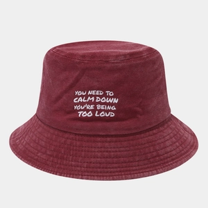 Detailed close-up of wine red washed cotton bucket hat with white text embroidery