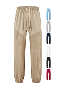 Detail of drawstring elastic waistband and multi-color fabric texture options on casual pants