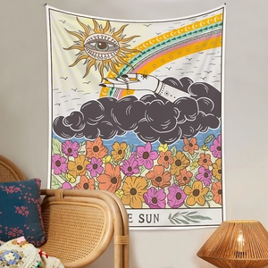 Detail showing Bohemian sun tarot tapestry hanging in a cozy home interior setting