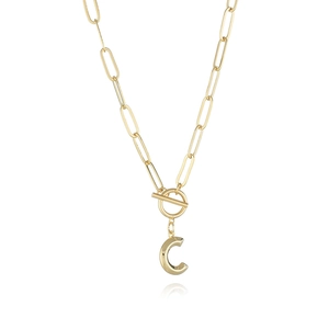 Detail of gold paperclip chain necklace with a large C letter pendant and OT toggle clasp