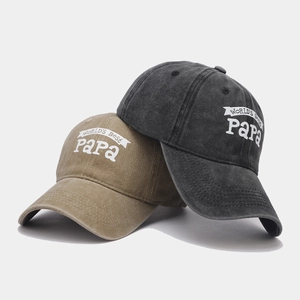 Detail of khaki and washed black baseball caps featuring World's Best Papa print