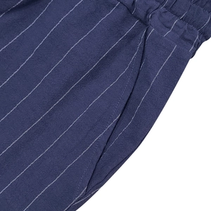 Detail of navy blue striped shorts showing elastic waistband and fine linen texture