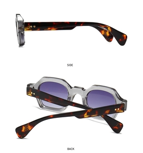 Detail view of narrow retro sunglasses with purple gradient lenses and tortoise temples