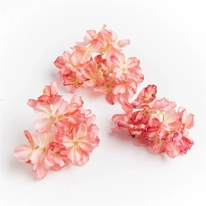 Detailed view of three pink artificial hydrangea petals with burnt edge craftsmanship