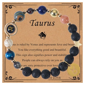 Detail of Taurus zodiac bracelet with natural volcanic stones and constellation charms