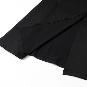 Close-up of black beach dress hemline showing high-quality stitching and smooth fabric