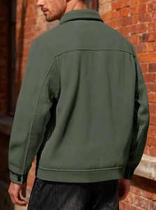 Detail view of the olive corduroy jacket back with vertical texture and back yoke seams
