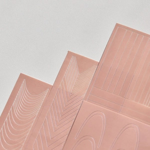 Macro detail of silicone tattoo practice skin showing various engraved geometric patterns