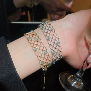 Detail of elegant gold and silver beaded hollow lace bracelets on a wrist