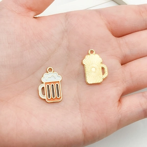 Detailed close-up of a creative beer mug pendant made of gold alloy with colorful oil drips