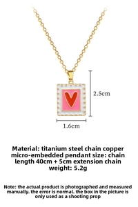 Detail view of pink enamel heart pendant with white polka dots on titanium steel chain