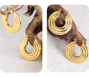 Macro detail showing gold geometric ripple texture on polished hoop earrings for women