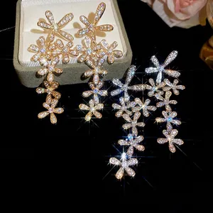 Elegant floral drop earrings with sparkling cubic zirconia tassels in gold and silver finish