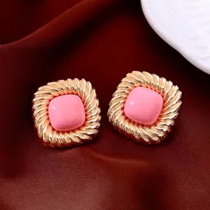 Vintage gold square stud earrings with pink resin center and twisted rope texture