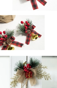 Close-up of Christmas hanging ornament with pine cones, red berries and gold bells