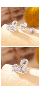 Detail view of silver bow stud earrings with sparkling cubic zirconia and screw back