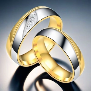 Close-up of two-tone gold and silver titanium steel couple rings with small diamonds